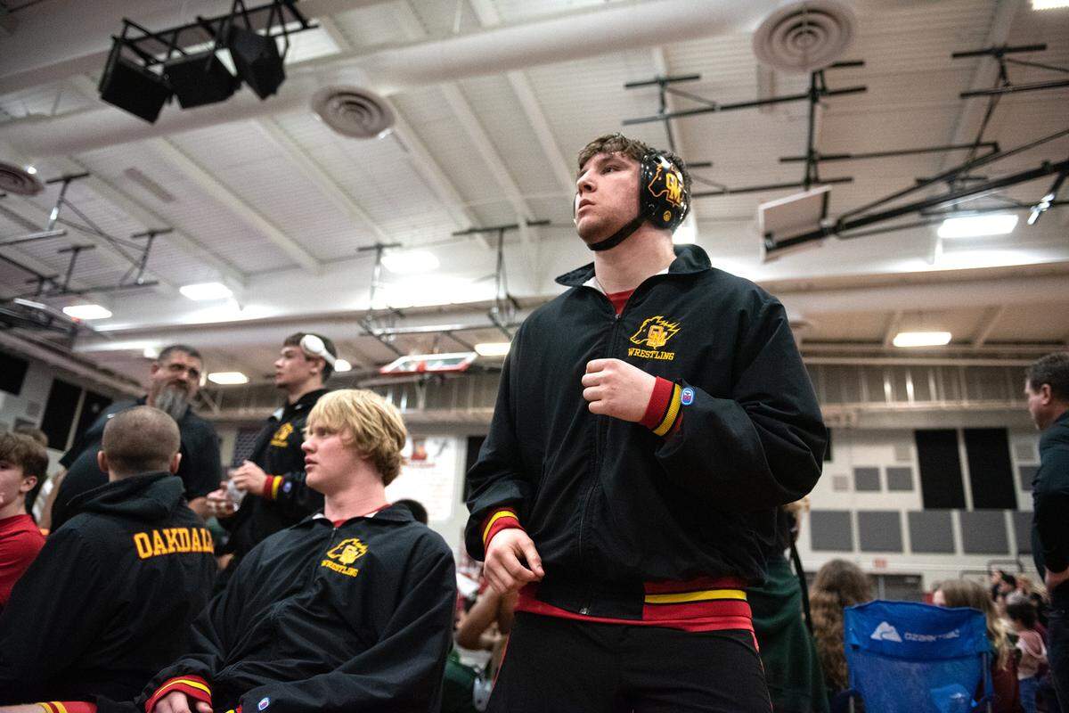 Oakdale’s Emilio Johnson watches the action as he prepares for his match in the Division 1 the Sac-Joaquin Section team dual wrestling championships at Lincoln High School in Stockton, Calif., Saturday, Jan. 28, 2023.