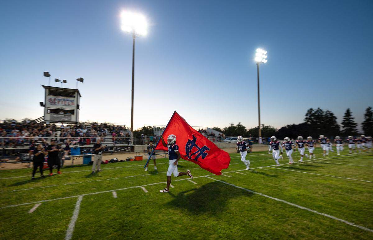 Modesto Christian players enter the stadium before the start of the nonleague game with Stone Ridge Christian at Modesto Christian High School in Salida, Calif., Friday, Sept. 15, 2023.