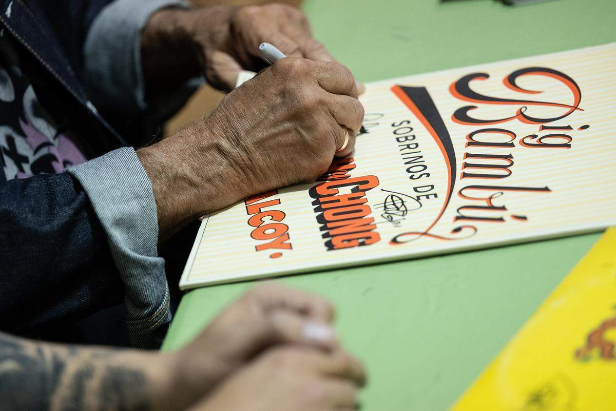 Cheech Marin of Cheech & Chong fame signs memorabilia for Jack Nguyen at Jayden’s Journey cannabis dispensary during Epilepsy Awareness Day in Modesto, Calif., on Friday, March 25, 2022.