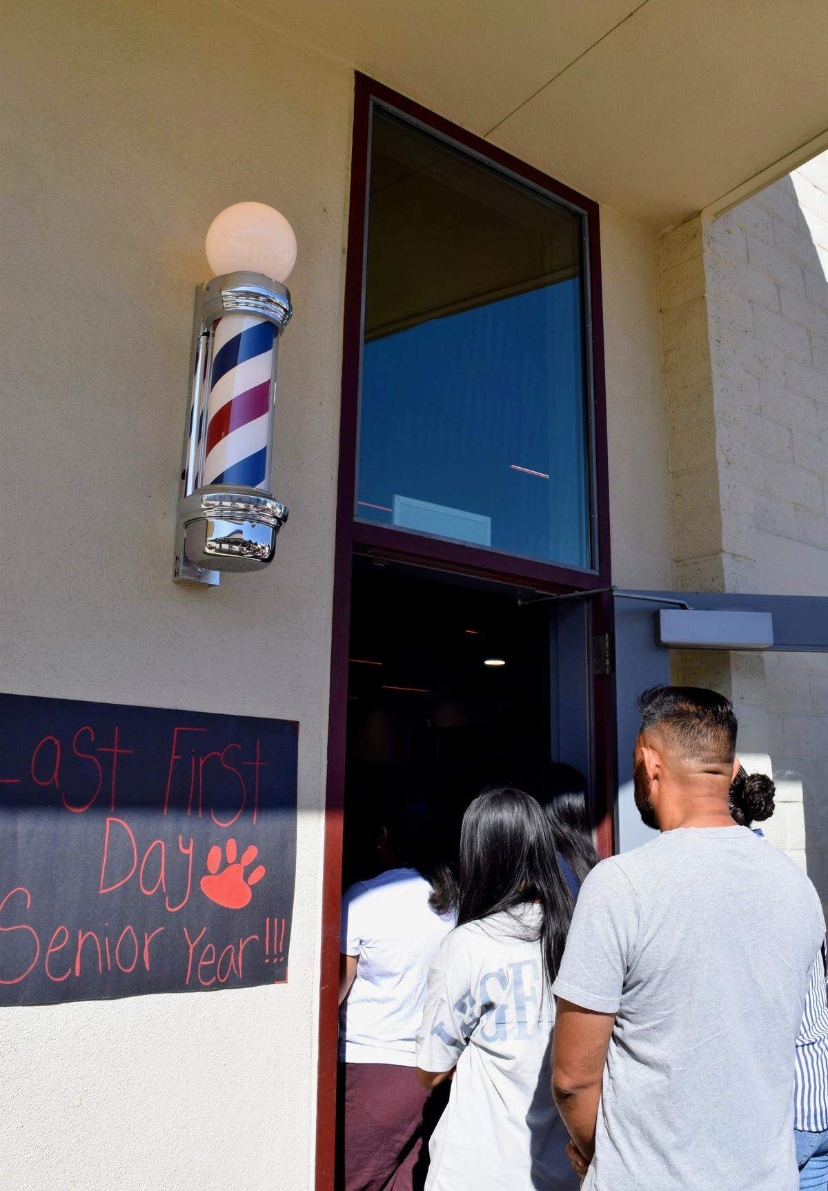 A barber pole greets visitors at the entrance of Patterson High School’s new Barbering and Cosmetology Building on Aug. 9, 2025.