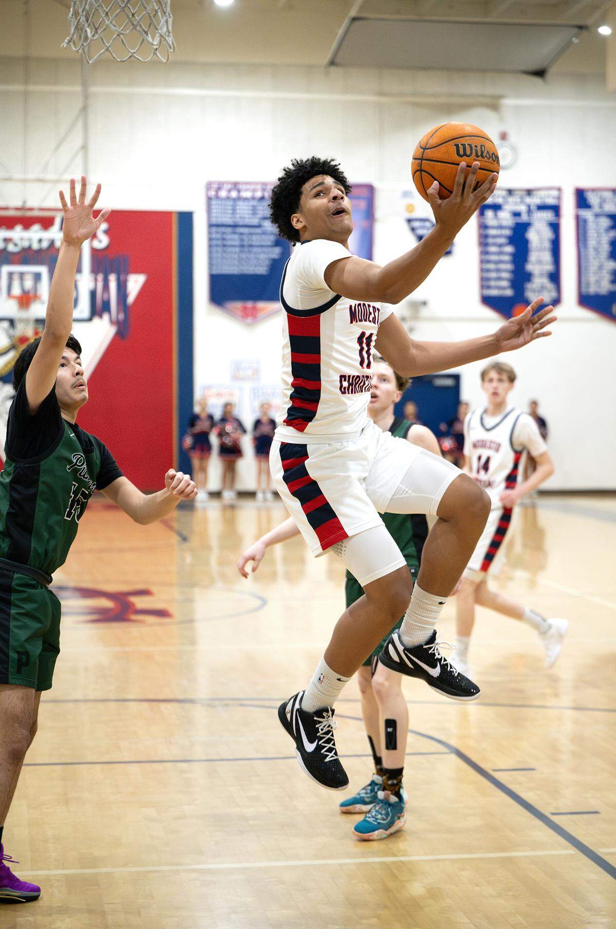 Modesto Christian’s Gavin Sykes drives past Pitman defenders during the Sac-Joaquin Section Division I playoff game at Modesto Christian High School in Salida on Wednesday, Feb. 19, 2025. Modesto Christian won the game 74-35.
