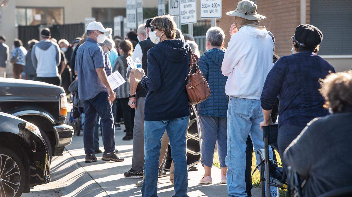 People wait at a COVID-19 Scenic Drive vaccination clinic in Modesto, Calif., on Thursday, Jan. 14, 2021.