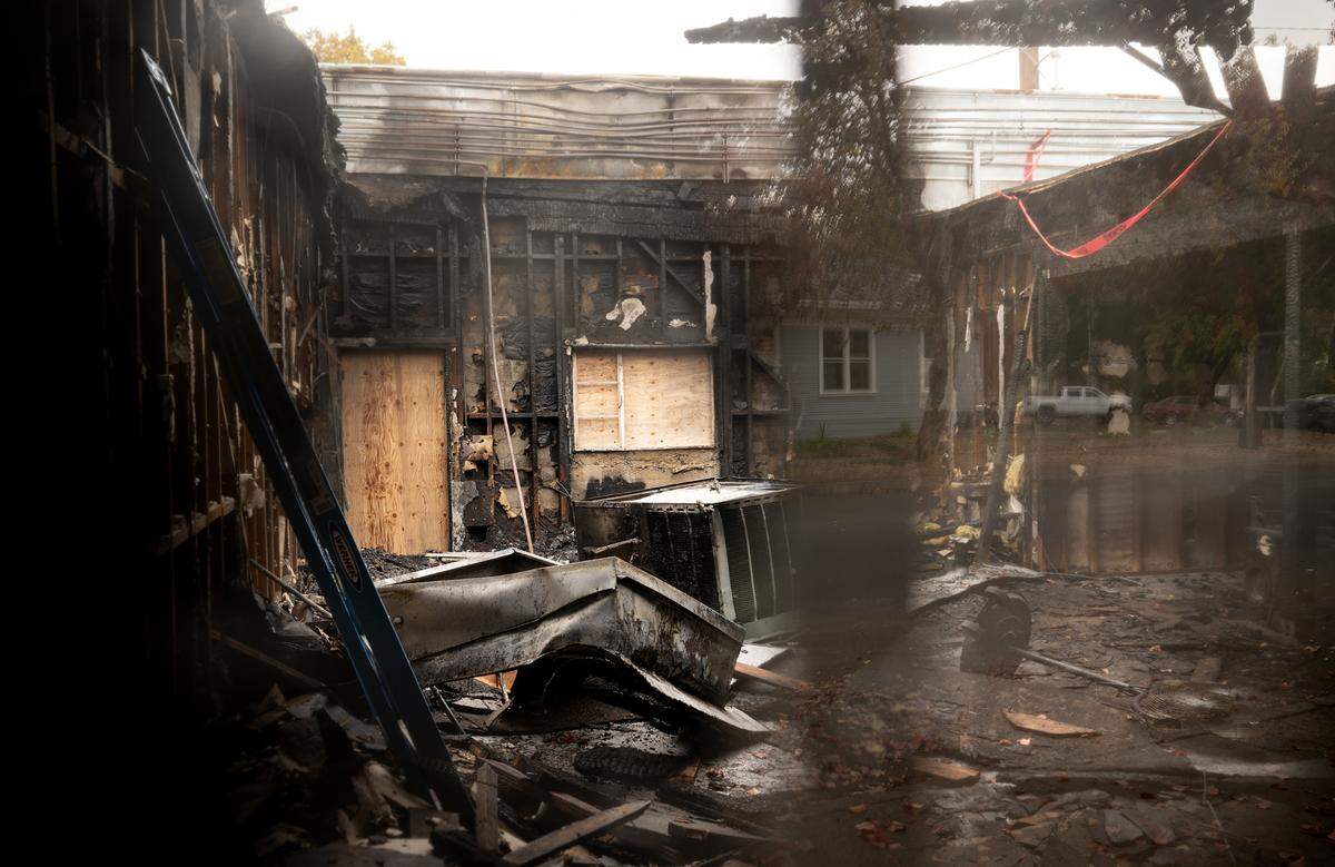 The damage from a early morning fire can be seen through a broken window, Gottschalk Music Center and Annex Hair Studios were damaged by the fire that started in the unit between the two businesses. Photographed in Modesto, Wednesday, Nov. 20, 2024.