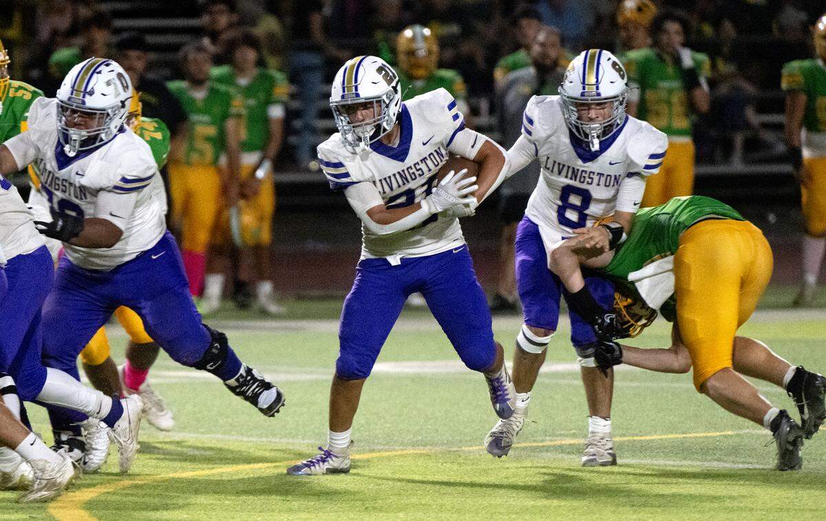 Livingston’s Ricardo Partida runs the ball during the Western Athletic Conference game with Grace Davis at Downey High School in Modesto, Calif., Thursday, Oct. 3, 2024.