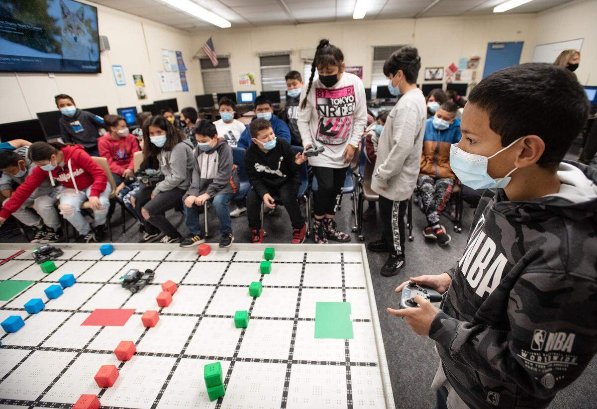 Fifth-grade student Angel G., navigates at robot through a maze during STEM class at Tuolumne Elementary School in Modesto, Calif., on Thursday, Feb.17, 2022.