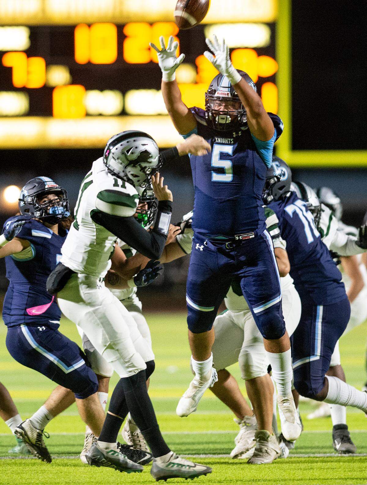 Downey’s Richard Williams pressures Pitman quarterback Drew Walker during the Central California Athletic League game at Downey High School in Modesto, Calif., Friday, Oct. 28, 2022.