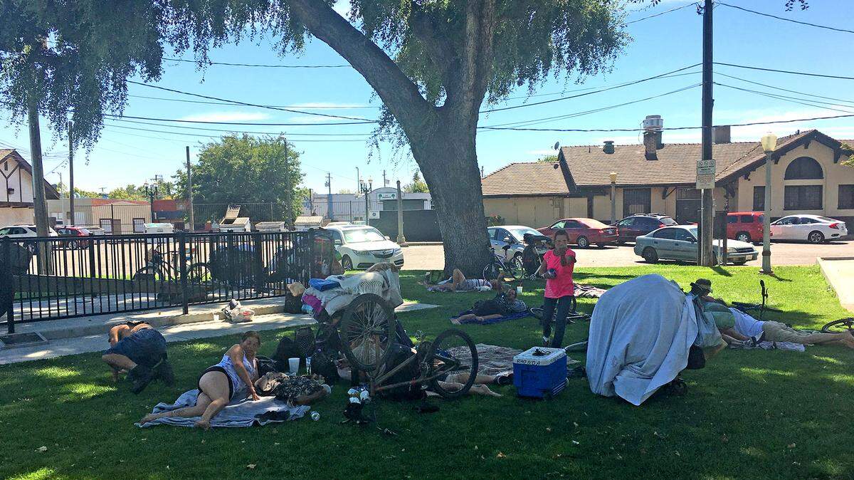 Homeless people are pictured at Central Park in downtown Turlock on Wednesday, July 25, 2018. 