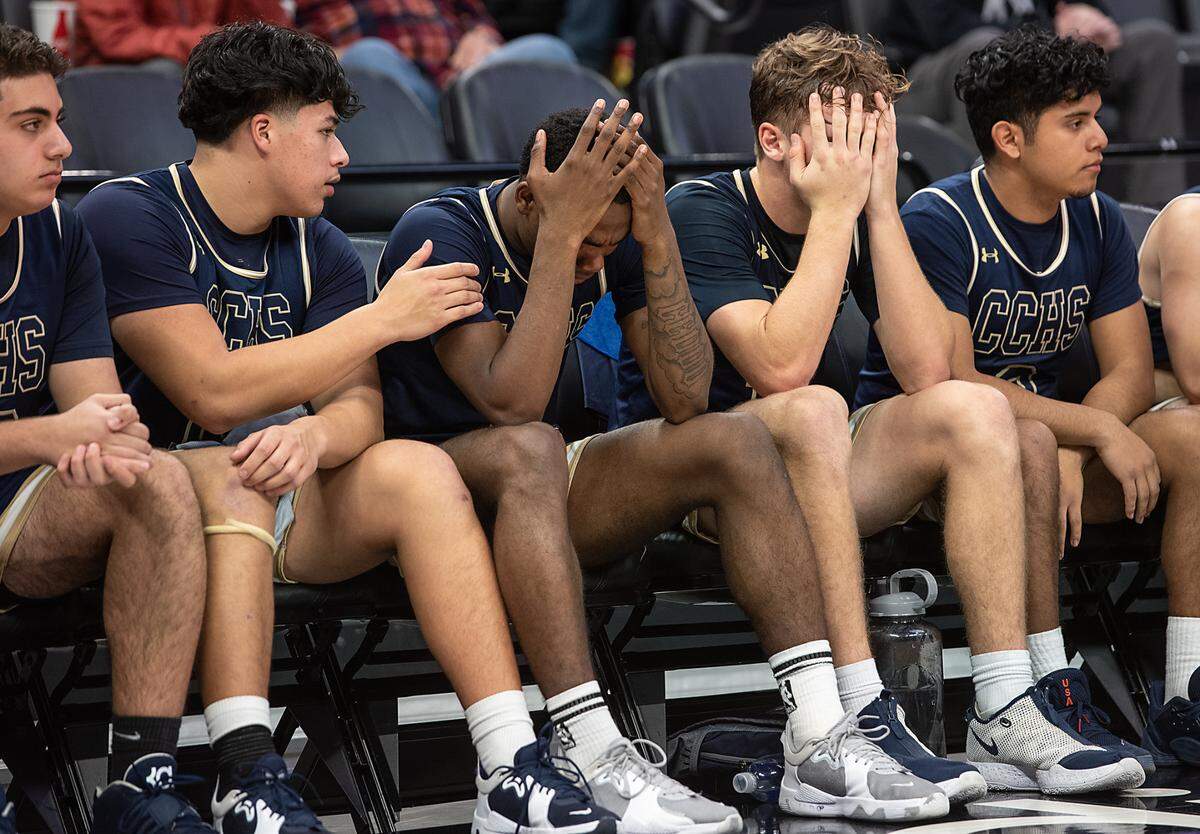 Central Catholic team members react to their 57-53 loss to Vanden in the boys Sac-Joaquin Section Division 3 final at the Golden 1 Center in Sacramento, Calif., on Saturday, Feb. 26, 2022.