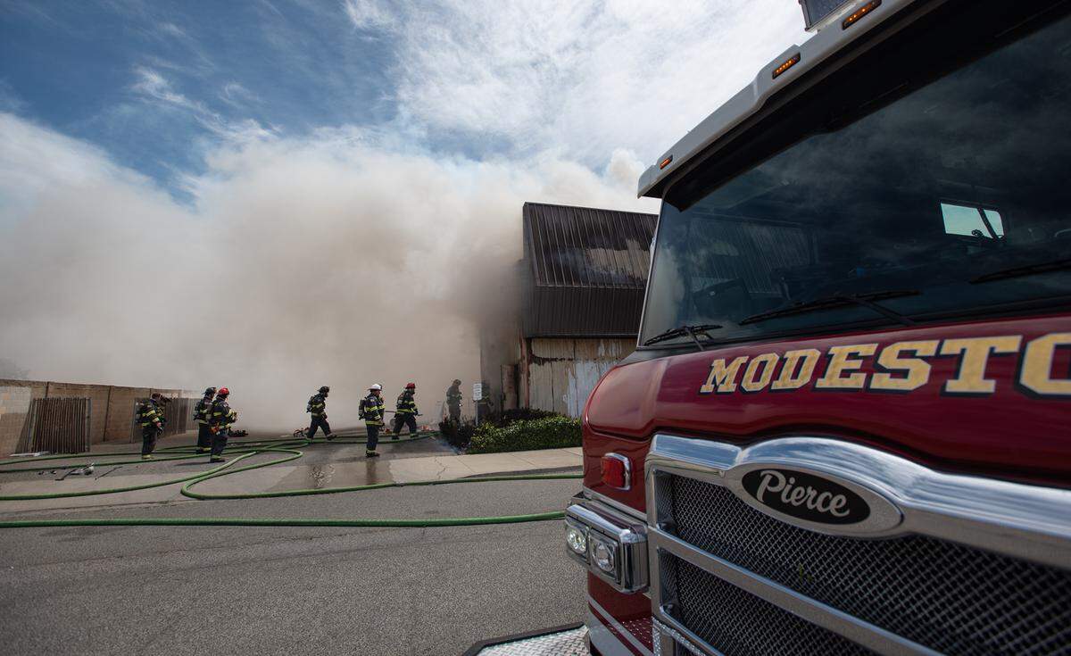 Firefighters battle a blaze at The Salvation Army Family Thrift Store and Donation Center on McHenry Avenue at Bangs Avenue in Modesto, Calif., on Thursday, June 2, 2022.
