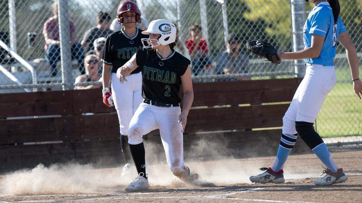 Pitman’s Rylee Reeves scores on a wild pitch during the Central California Athletic League game with Downey at Pitman High School in Turlock, Calif., Tuesday, March 19, 2024.