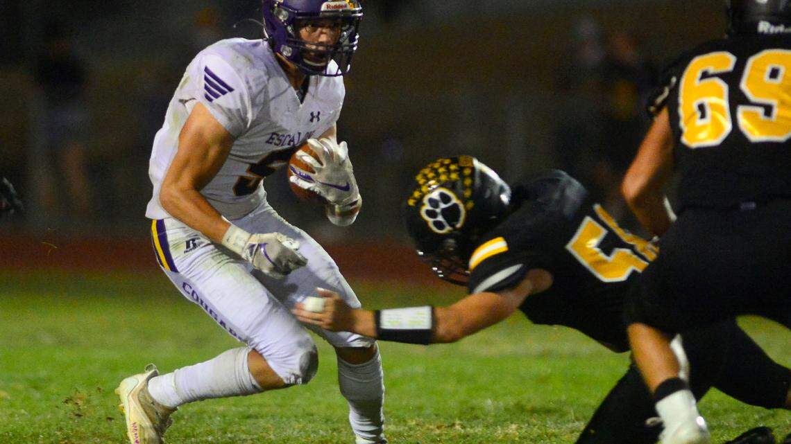 Escalon running back Logan Anderson (5) jukes multiple defenders during a football game between Hughson High School and Escalon High School at Hughson High School in Hughson California on September 17, 2021