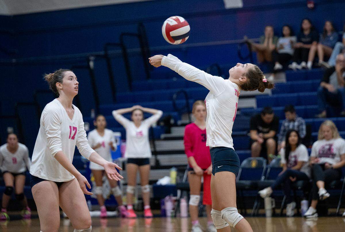 Turlock’s Alaina De Sousa, right, sets the ball in the Central California Athletic League match with Pitman at Turlock High School in Turlock, Calif., Tuesday Oct. 8, 2024.