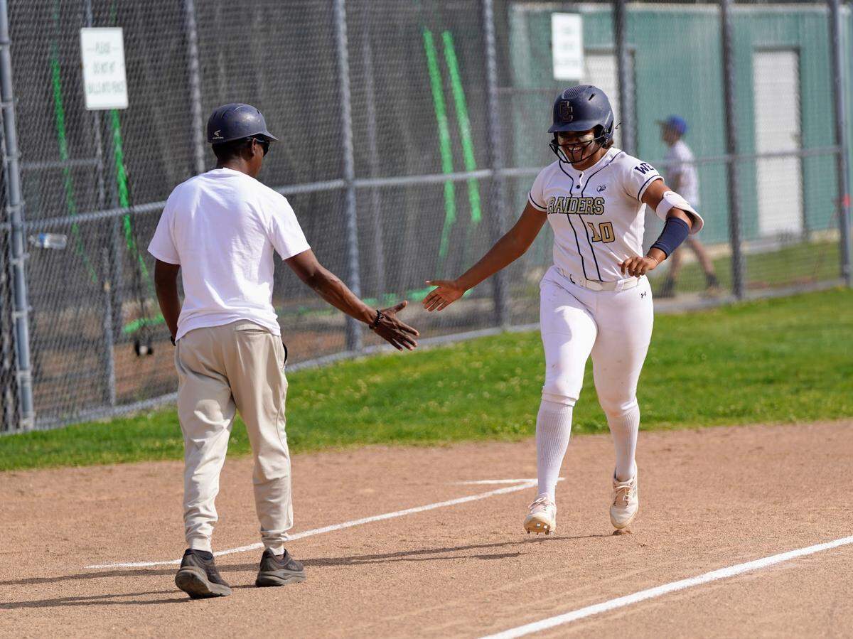Central Catholic’s Madie Harrison high fives coach Sam Nichols after hitting her first home run during a Valley Oak League game against Manteca at Manteca High School on Tuesday, April 22, 2025.