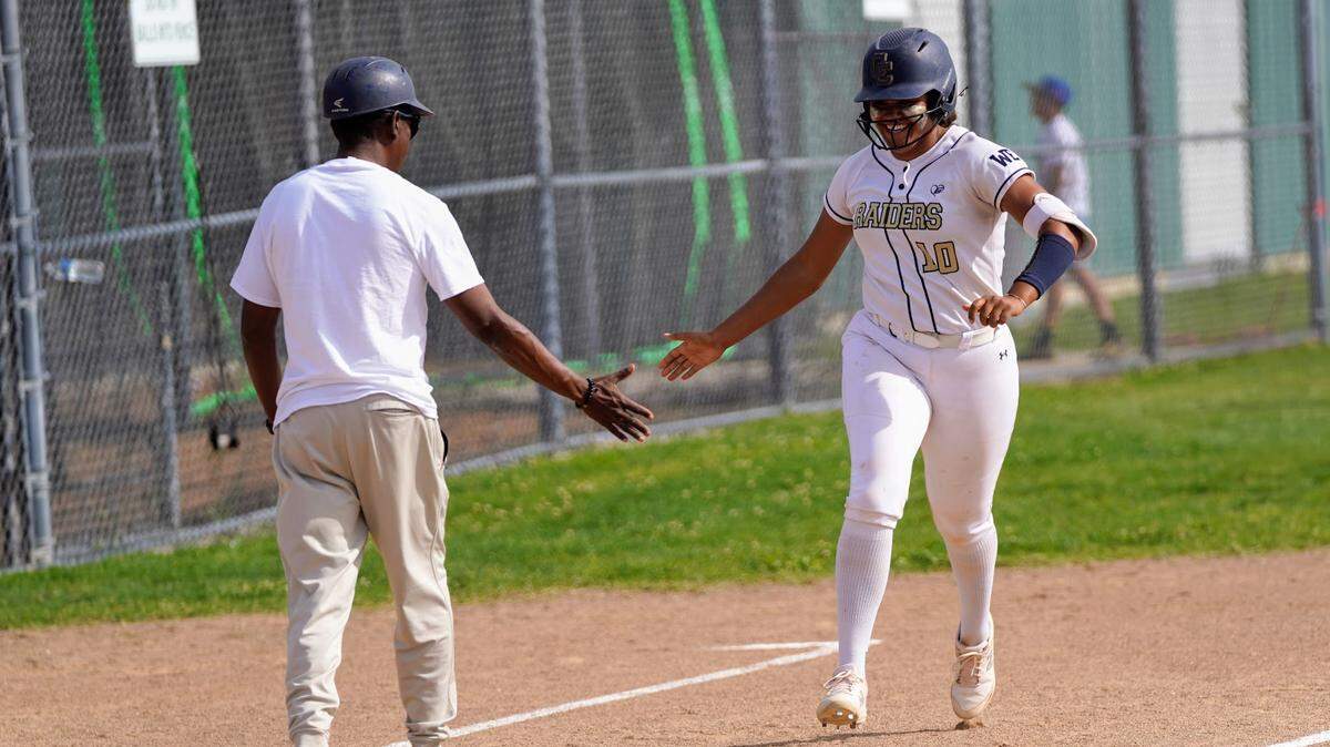 Central Catholic’s Madie Harrison high-fives coach Sam Nichols after hitting her first home run during a Valley Oak League game against Manteca at Manteca High School on Tuesday, April 22, 2025.