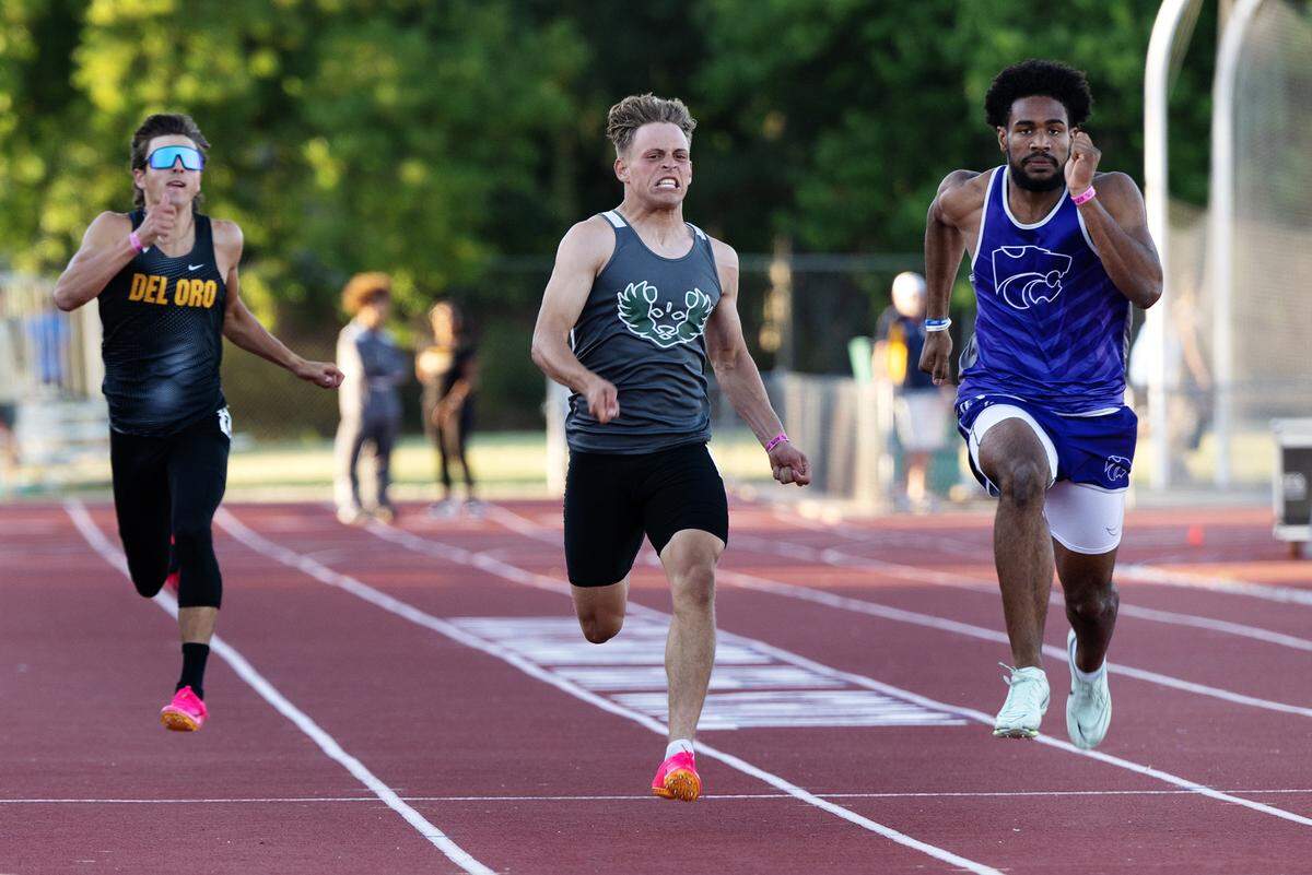 Pitman’s Joey Stout, middle, challenges Ian Dossman of Franklin-EG, right, in the 200 meter race during the CIF Sac-Joaquin Section Masters track finals at Davis High School in Davis, Calif., Saturday, May 20, 2023. Stout finished second with a time of 21.84.