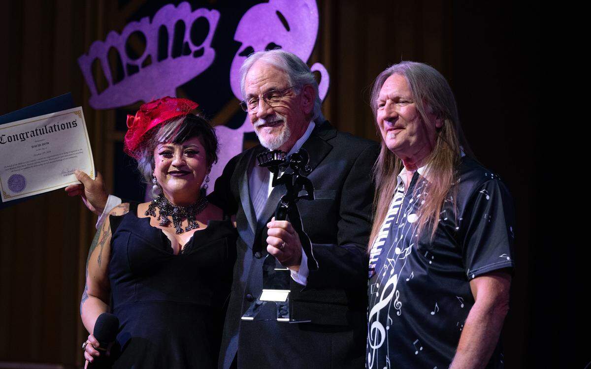 Dave Dow was presented with the lifetime achievement award by Melynda Rodriguez, left, and Jeff Chilton during the Modesto Area Music Association’s MAMA awards show at the State Theatre in Modesto, Tuesday, Oct. 15, 2024.