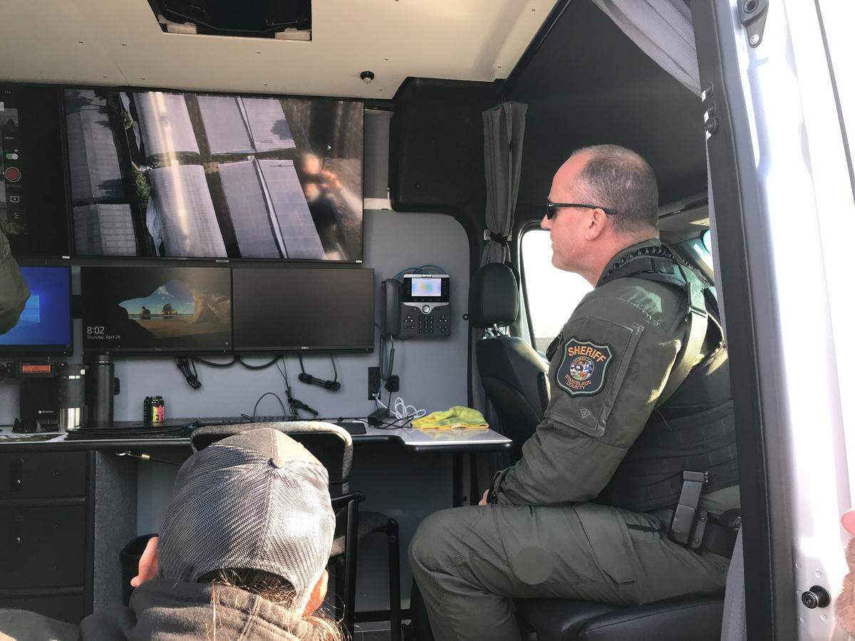 At a mobile command post, Stanislaus County Sheriff Jeff Dirkse views drone overhead footage of an illegal marijuana grow during a warrant search on Olivera Road in south Modesto on Thursday, April 28, 2022.