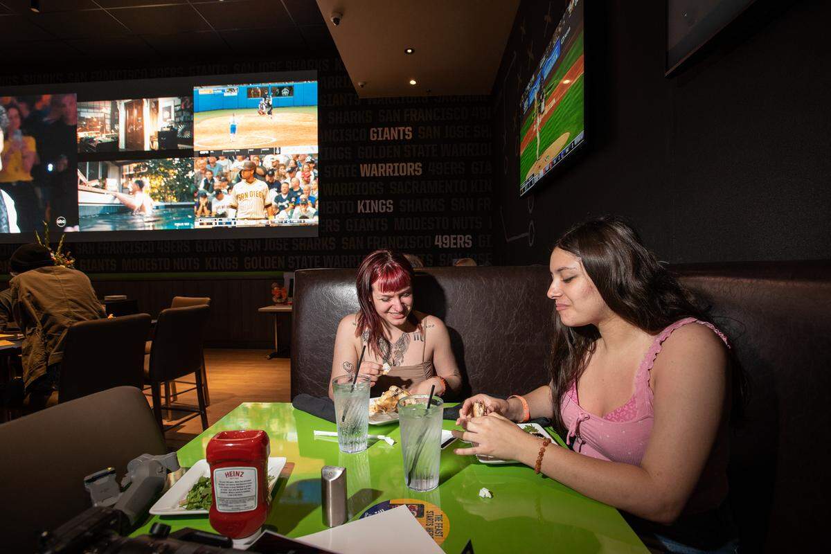 Rachel Madrigal, left, and her niece Natalia Madrigal enjoy a VIP buffet at Dave & Buster’s entertainment center and restaurant at Vintage Faire Mall in Modesto, Calif., on Thursday, June 2, 2022.