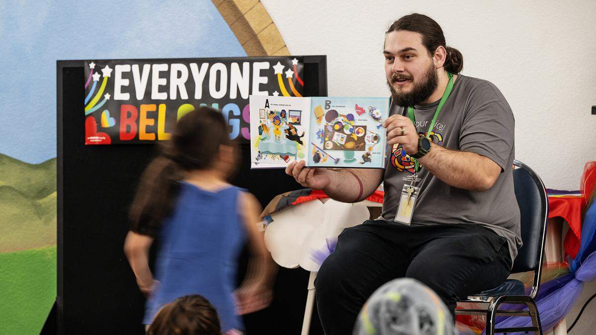 Library assistant Teddy Snyder reads “Pride Puppy!” by Robin Stevenson during Rainbow Story Time at the Stanislaus County Library in Salida, Calif., Thursday, June 15, 2023.
