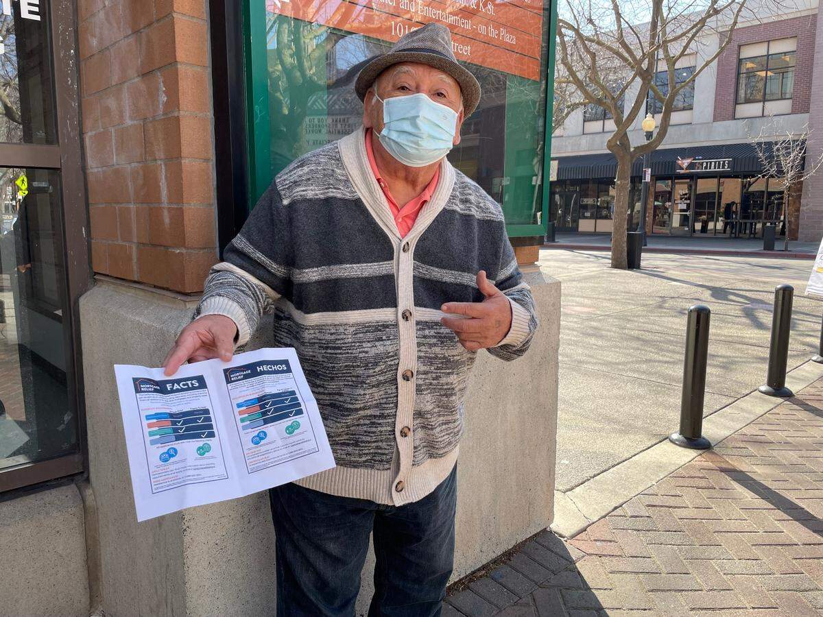 Miguel Donoso, an outspoken advocate for Spanish speakers in Stanislaus County, stands outside the county administrative offices, holding a flier that is available in both English and Spanish. January 26, 2023.