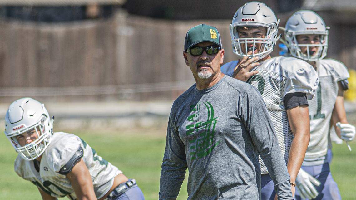 Head Coach Frank Marques and his Hilmar football squad looks to do big things again this season behind quarterback Seth Miguel, right, during practice on Thursday, August 8, in Hilmar.