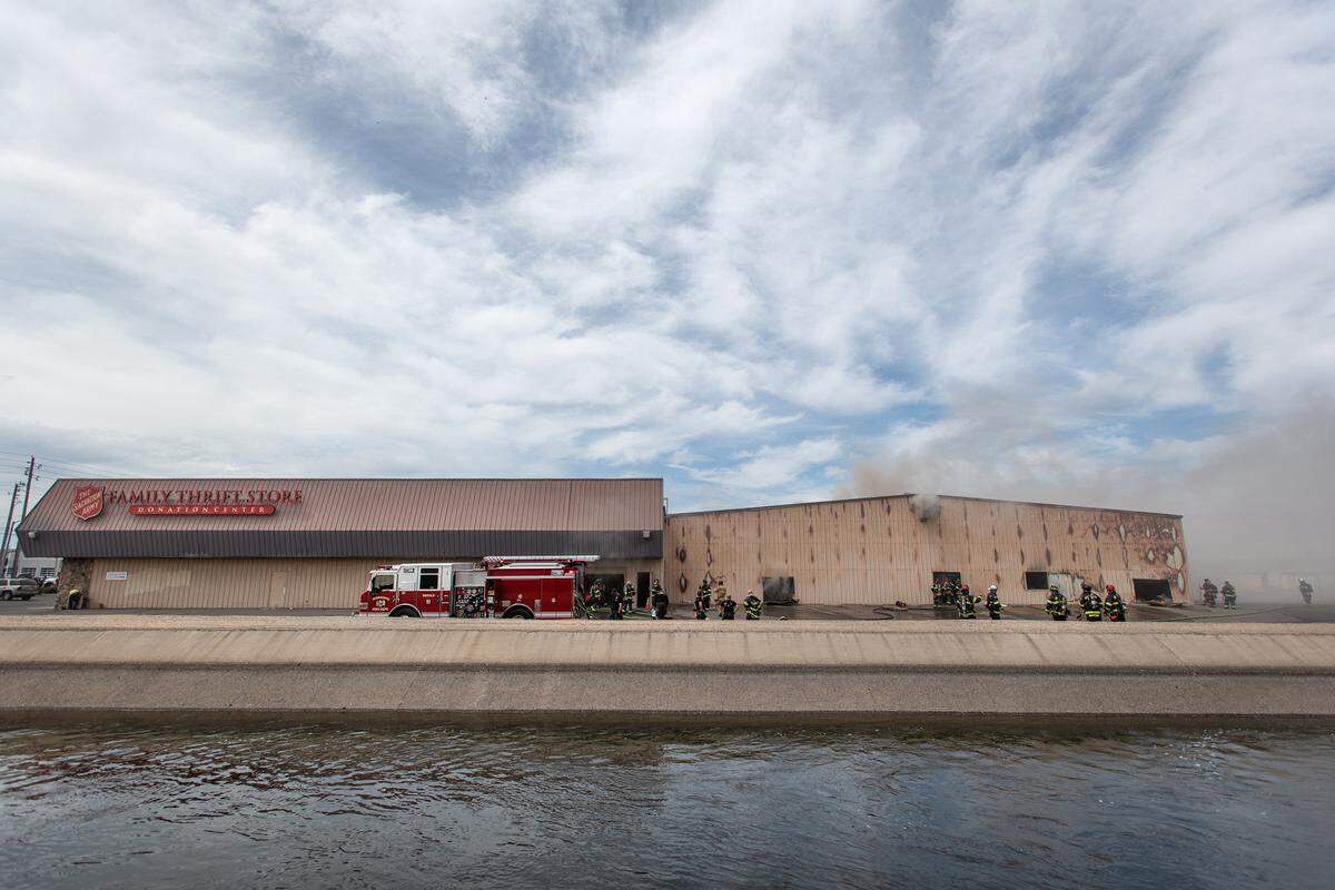 Firefighters battle a blaze at The Salvation Army Family Thrift Store and Donation Center on McHenry Avenue at Bangs Avenue in Modesto, Calif., on Thursday, June 2, 2022.