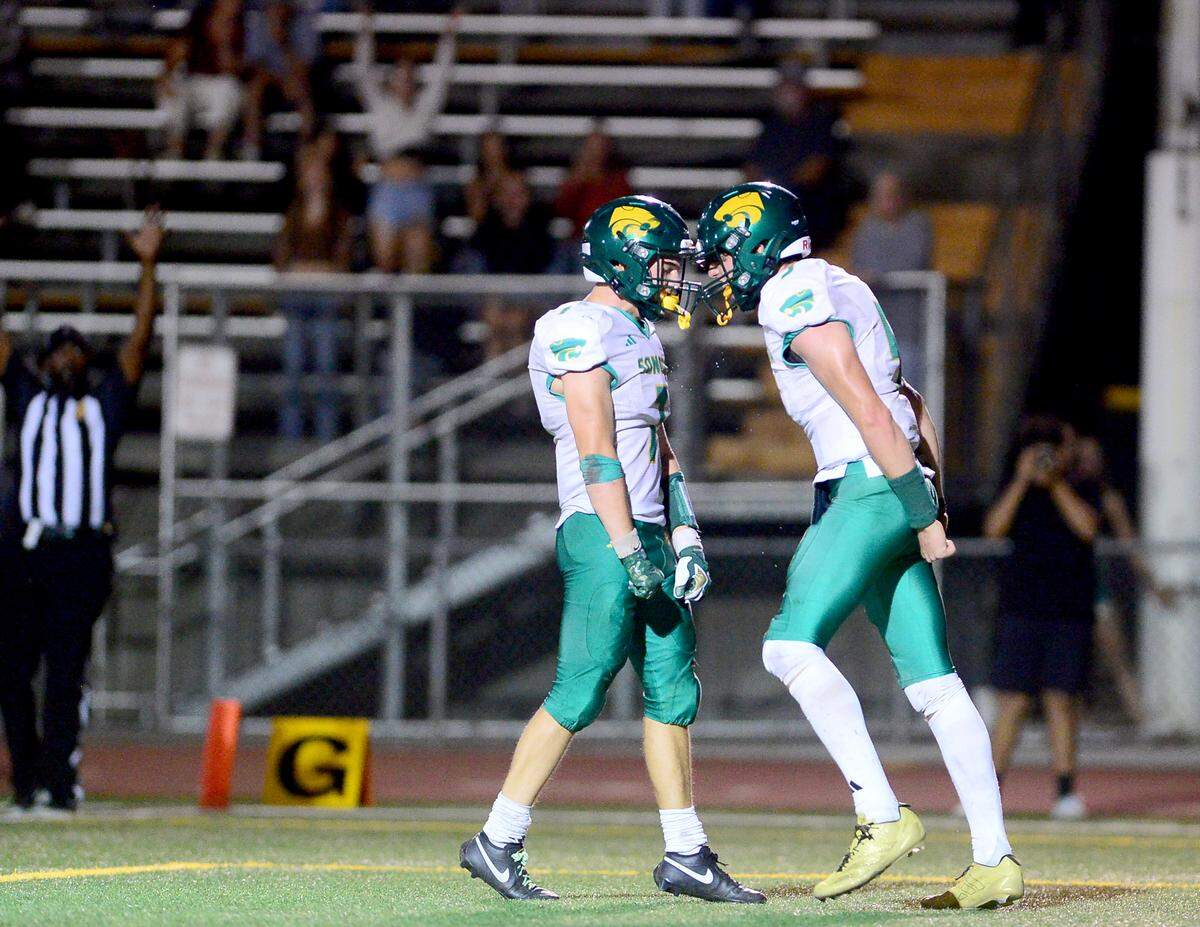 Sonora quarterback Eli Ingalls (5, right) celebrates with Cash Byington (7, left) after Ingalls scored a touchdown during the game with Turlock at Turlock High School on Sept. 12, 2025.