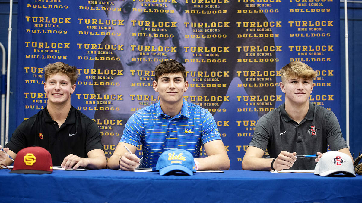 Turlock High School seniors, from the left, Andy Owen, Tyler Soderstrom and Cole Carrigg signed their National Letters of Intent at Turlock High School in Turlock, Calif., Wednesday, Nov. 13, 2019. Owen is heading to USC, Soderstrom is going to UCLA and Carrigg will attend San Diego State.