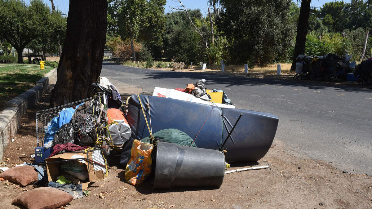Homeless belongings and junked items are pictured Friday August 17, 2018 in Legion Park in Modesto, Calif.