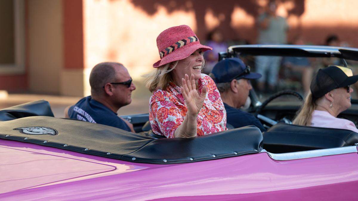 Candy Clark, star of George Lucas’ film “American Graffiti”, waves to spectators during the 2022 classic car parade in Modesto.