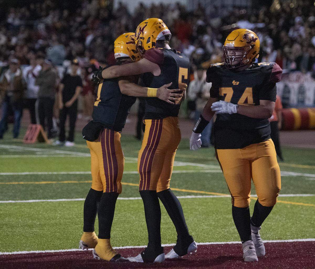 Los Banos players celebrate a touchdown in the first half against Atwater during Friday night’s Central California Conference finale at Loftin Stadium in Los Banos.