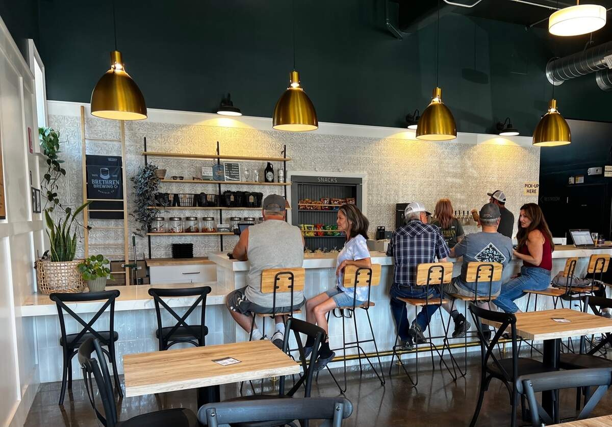 Customers sit at the bar top of Brethren Brewing Company Friday, June 30, 2023.