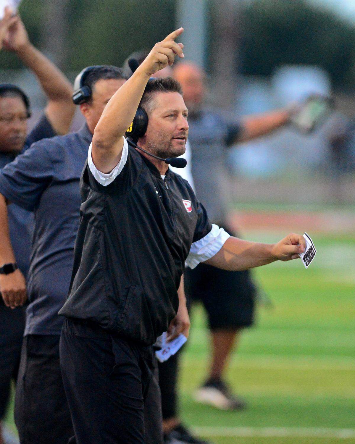 Patterson head coach Rob Cozart celebrates a defensive stop during a game between Patterson High School and Merced High School at Patterson High on Aug. 23, 2024.