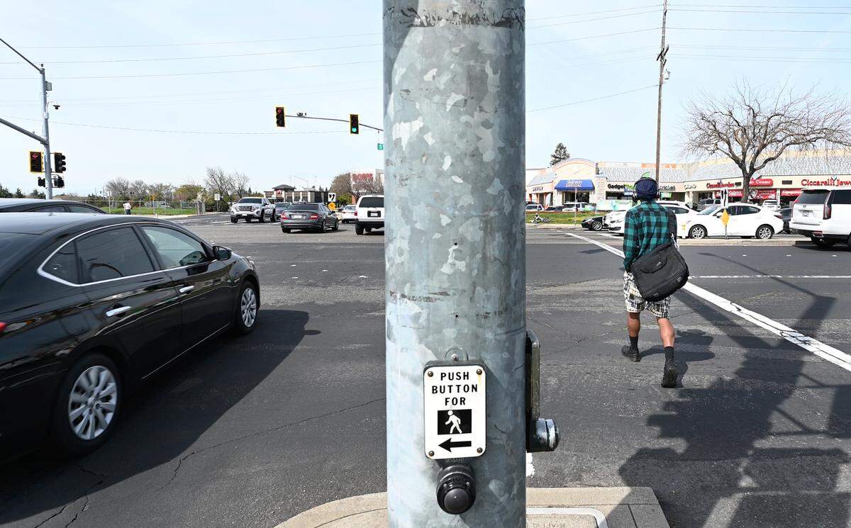 A pedestrian crosses Standiford Avenue on Sisk Road in Modesto, Calif., Saturday, March 9, 2024.