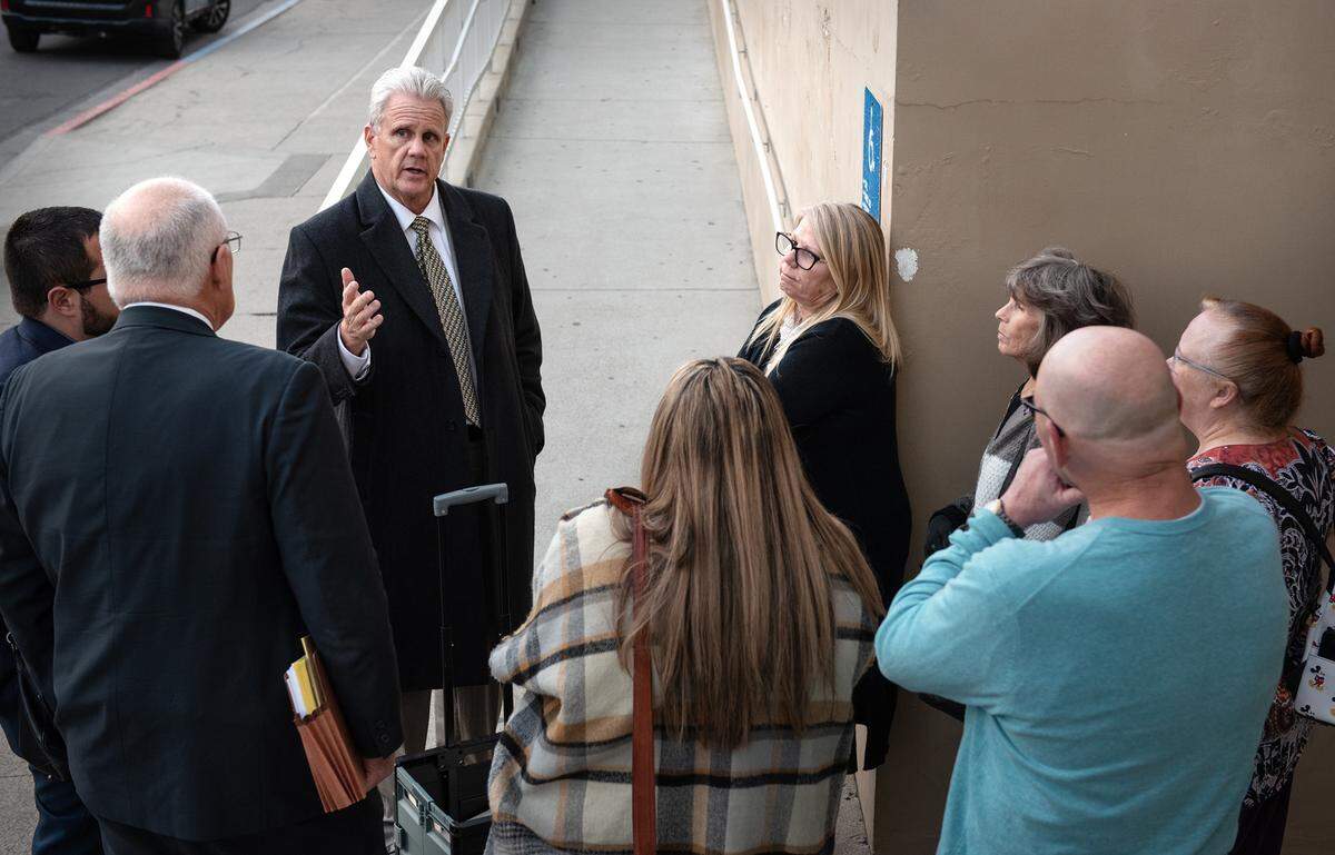 Deputy District Attorney Rick Mury talks with the family of Trevor Seever outside the Stanislaus County Superior Court in Modesto, Calif., Tuesday, Nov. 22, 2022. Seever was killed by Modesto Police officer Joseph Lamantia in 2020. A hearing is being held before Judge Carrie Stephens to determine whether there is enough evidence for Lamantia to stand trial.