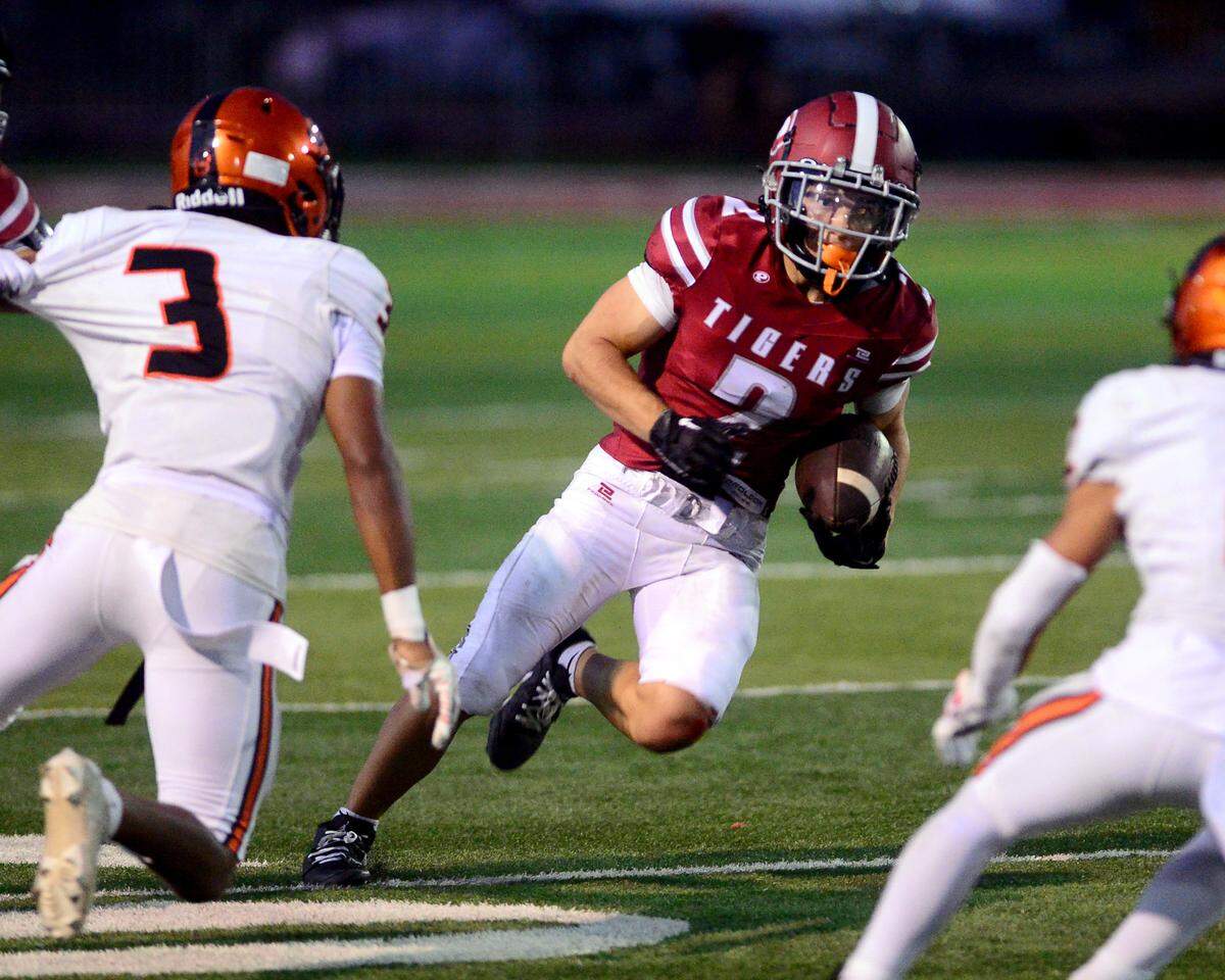 Patterson receiver Noah Cozart (2) cuts upfield after catching a screen pass during a game between Patterson High School and Merced High School at Patterson High on Aug. 23, 2024.