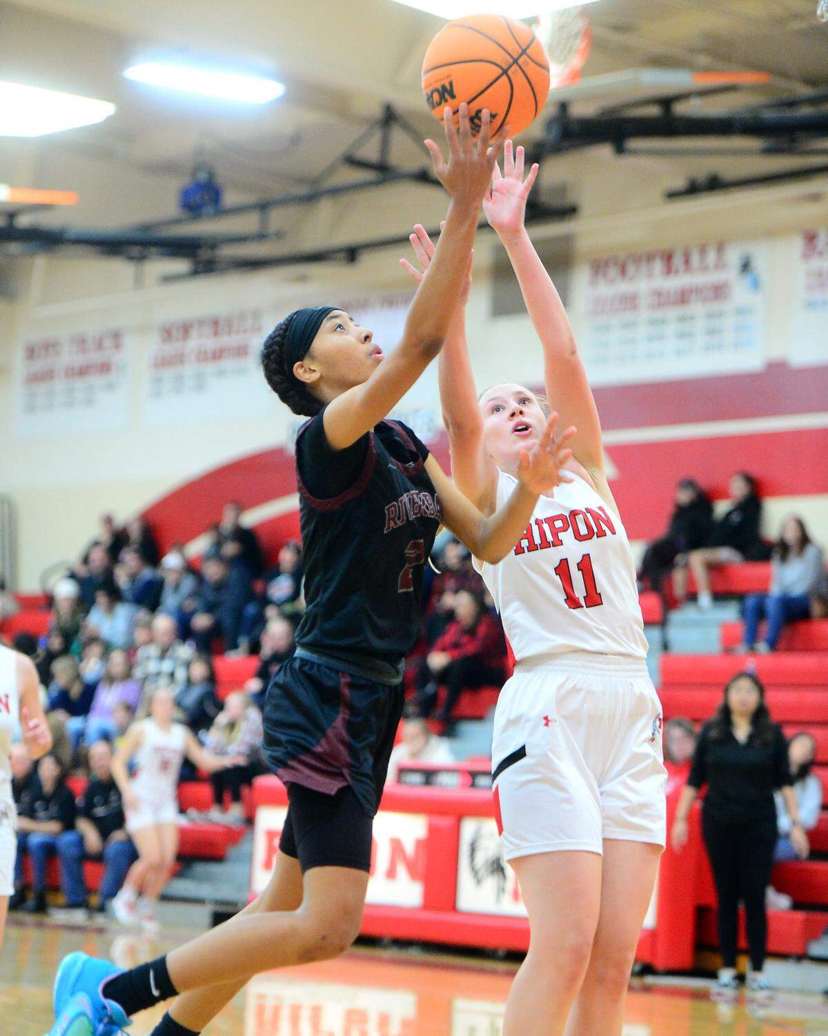 Riverbank guard Taylor Macias (2) lifts the ball for a layup during a game between Ripon High School and Riverbank High School at Ripon High School in Ripon California on January 5, 2023.