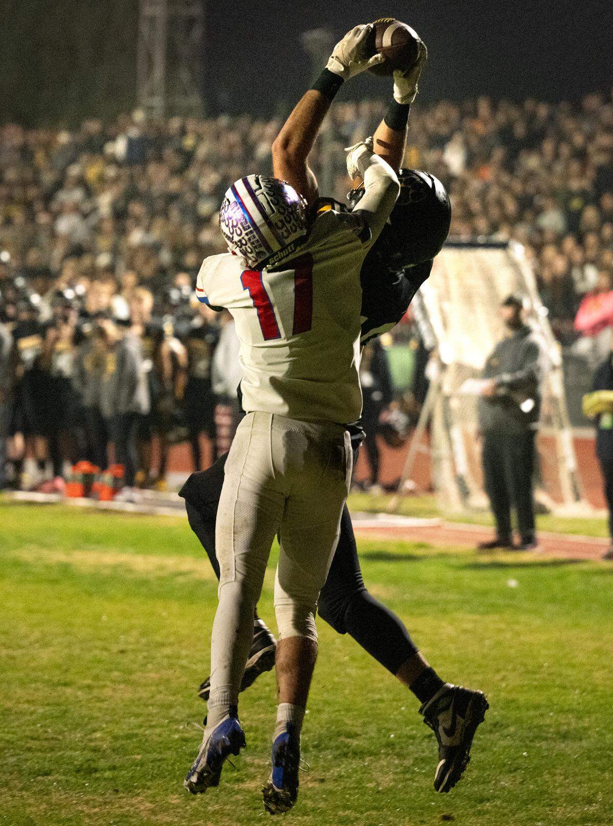 Hughson’s Max Mankins makes a touchdown catch over St. Vincent’s Asher Stolarczyk during the CIF Northern California Division 4-AA Bowl Game with St. Vincent de Paul in Hughson, Friday, Dec. 6, 2024.