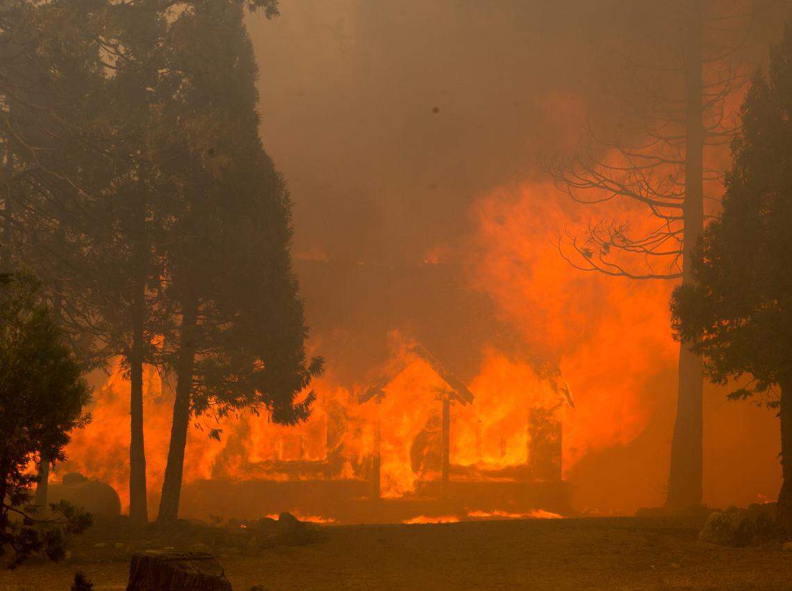 A home along Highway 108 is overtaken by flames as the Donnell Fire in Tuolumne County rapidly advances along Highway 108 Sunday Aug. 5, 2018. 