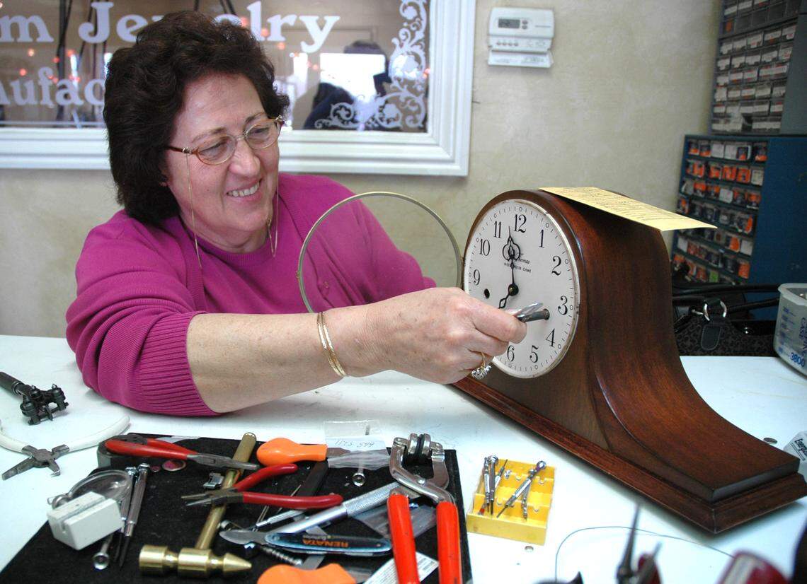 Rosemary Yonan winds a Seth Thomas clock after repairing it in 2006.  