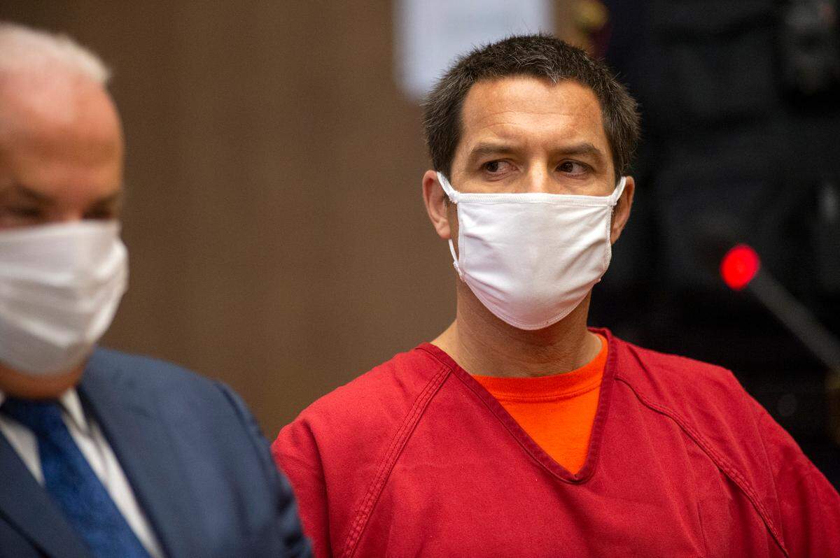 Scott Peterson listens to Stanislaus County Deputy District attorney Dave Harris speak during a hearing at the San Mateo County Superior Court in Redwood City, Calif., Dec. 8, 2021. Peterson appeared in San Mateo Superior Court for the first time since he was sentenced to death there more than 17 years ago for the murders of his wife Laci and their unborn son Conner. (POOL-Andy Alfaro,The Modesto Bee)