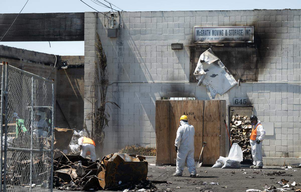 A crew clears the property of McGrath Moving and Storage which was destroyed by fire from an adjacent burning pallet business on Aug. 9. Photographed in Modesto, Calif., Wednesday, Aug. 14, 2024.