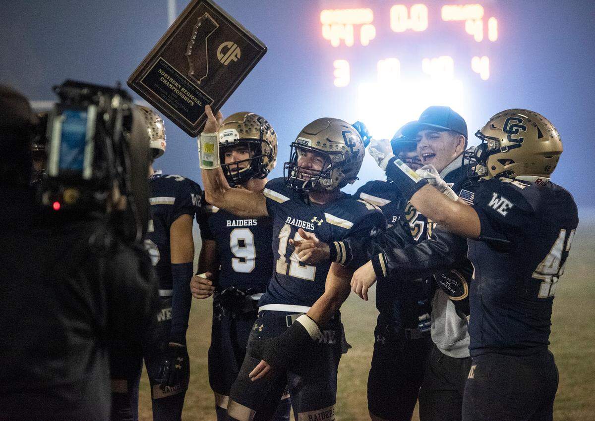 Central Catholic players celebrate their 44-41 victory over Bullard in the CIF Division II Northern California Regional Championship game at Central Catholic High School in Modesto, Calif., Dec. 3, 2021.