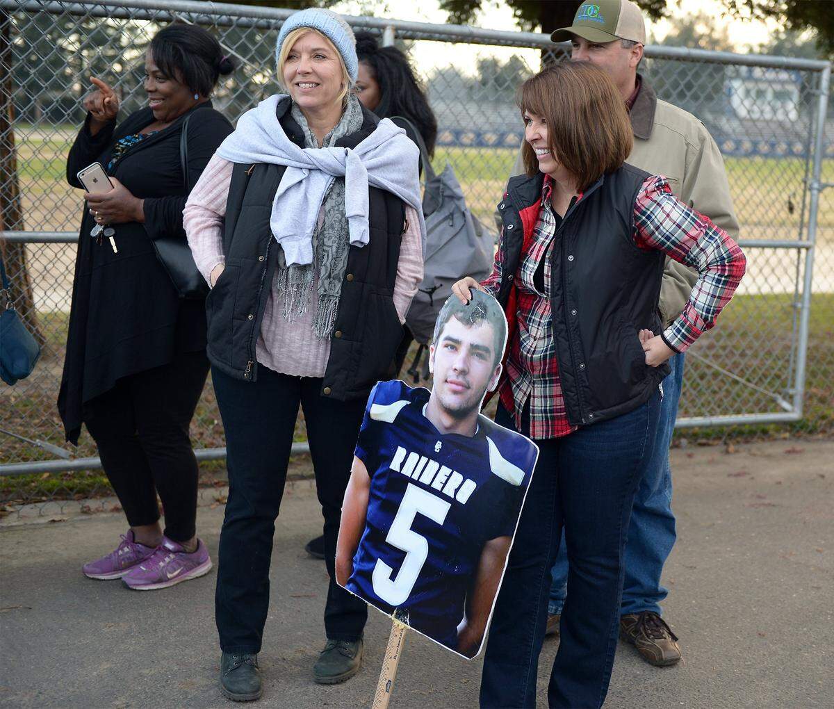 Lisa Days holds a cutout of her son Josh on Dec. 18, 2015, at Central Catholic High School before the team left the Modesto school for its State Title game.