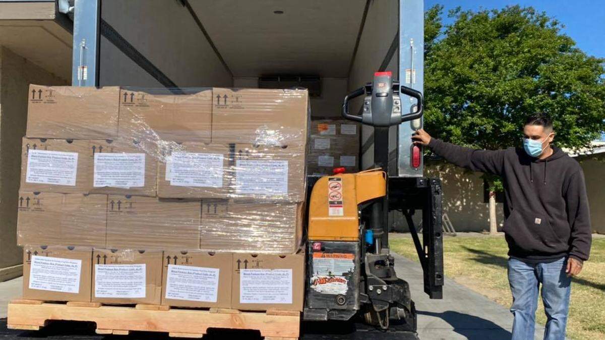 Ag Link driver Mike Garcia delivers food to Wakefield School in Turlock, California, on Friday, May 15, 2020. Ag Link has a contract with the U.S. Department of Agriculture to supply a larger volume to schools and nonprofits because of the coronavirus.