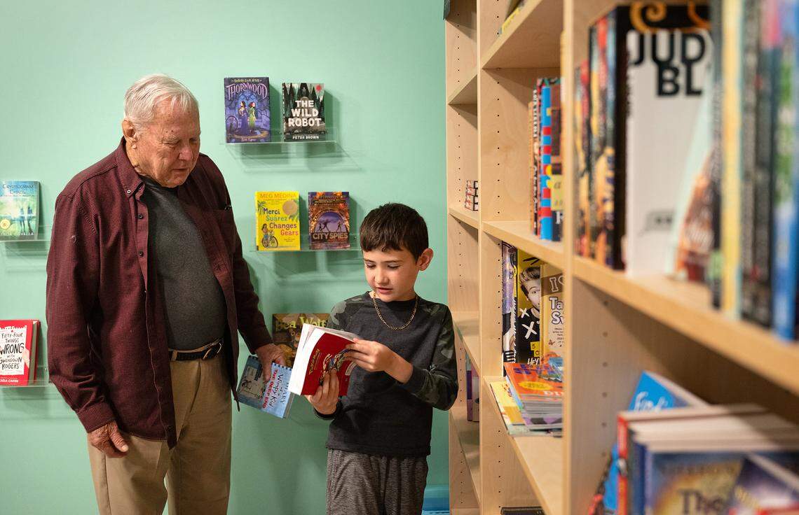 Byron Gregerson and his grandson Lucca, 9, browse books at Bookish in Modesto, Calif., Tuesday, April 4, 2024.