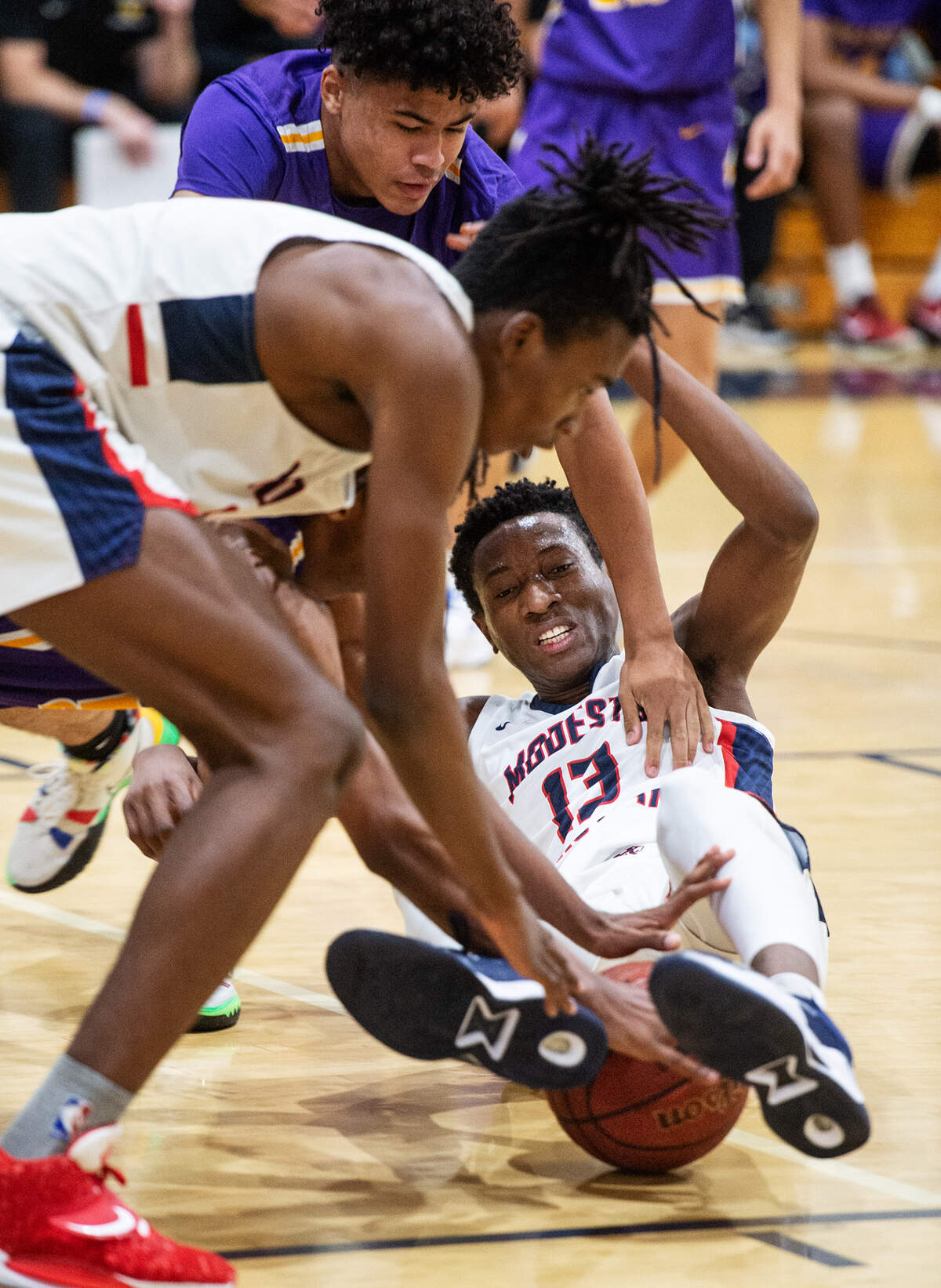 Modesto Christian’s Prince Oseya (13) battle for a loose ball during the Holiday Hoops Classic championship game with Durango NV in Salida, Calif., on Thursday, Dec. 30, 2021.