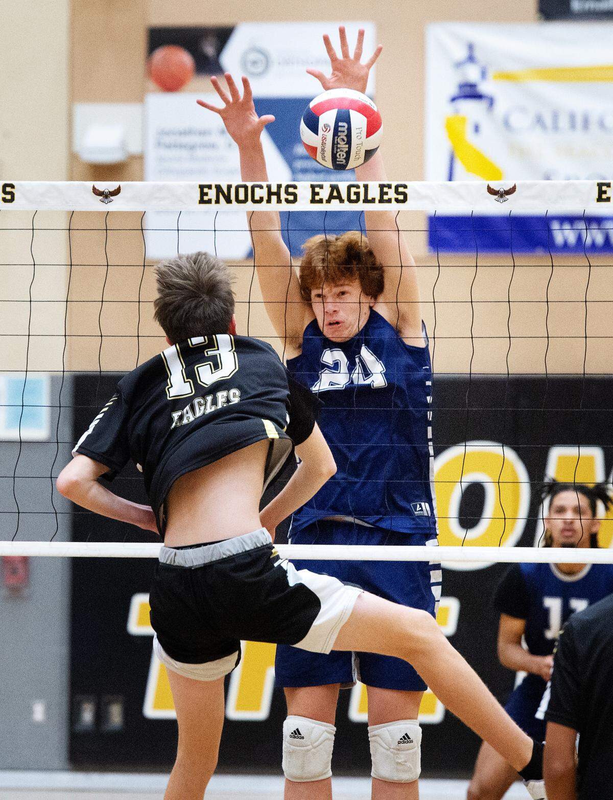 Downey’s Jack Fisher (24) blocks the shot of Enochs’ Thomas Harmon during the Central California Athletic League match at Enochs High School in Modesto, Calif., Tuesday, April 4, 2023.