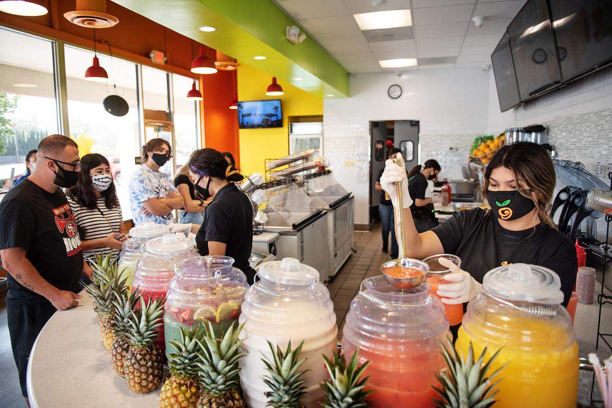 Criselda Perez pours a strawberry aguas at Mango Crazy which celebrated the opening of it’s newest store on McHenry Avenue in Modesto, Calif., on Wednesday, Sept. 16, 2020.