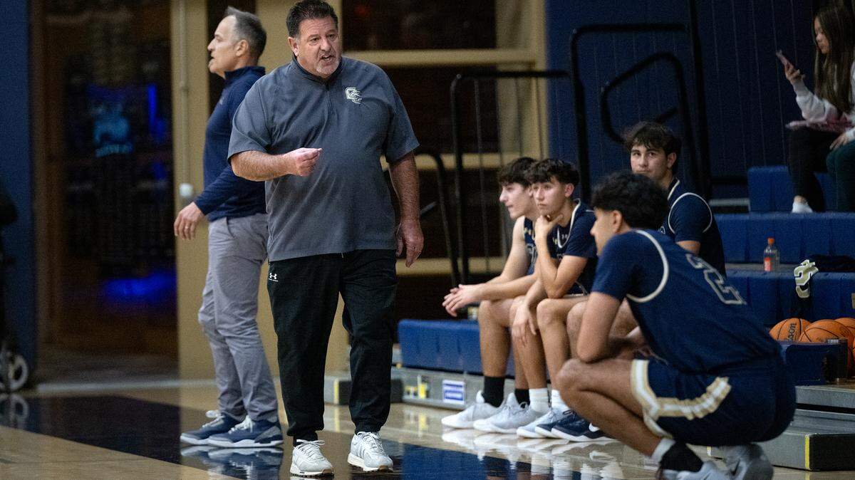 Central Catholic coach Mike Wilson talks to his players during the Mark Gallo Invitational basketball tournament game with Atwater at Central Catholic High School in Modesto, Friday, Dec. 13, 2024.